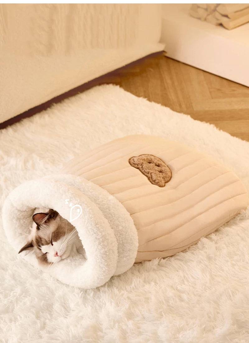 Heated cat tunnel made from soft plush material, providing a warm shelter.